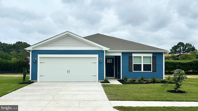 view of front of home with a garage and a front lawn