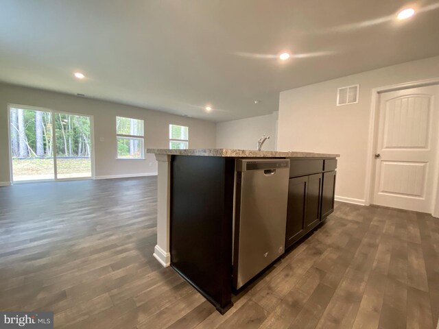 kitchen with dishwasher, dark hardwood / wood-style flooring, dark brown cabinets, and an island with sink