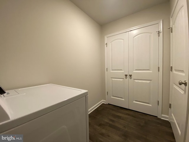 clothes washing area with washer and clothes dryer and dark wood-type flooring