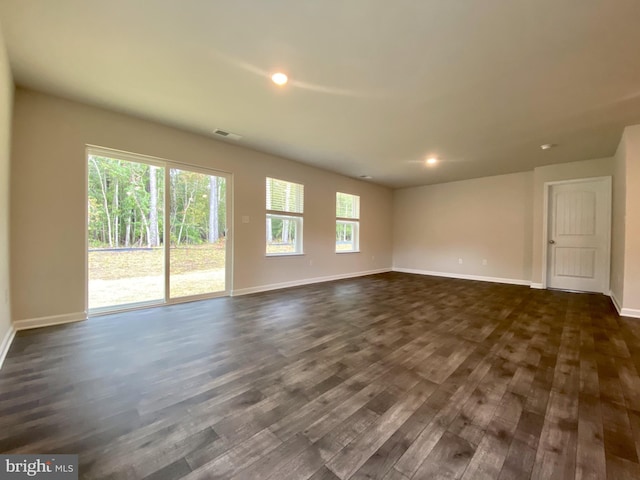 spare room featuring dark wood-type flooring