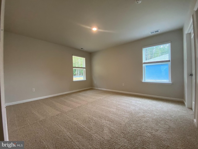 unfurnished room with light colored carpet