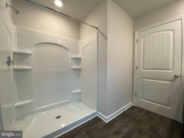 bathroom featuring a shower and hardwood / wood-style floors