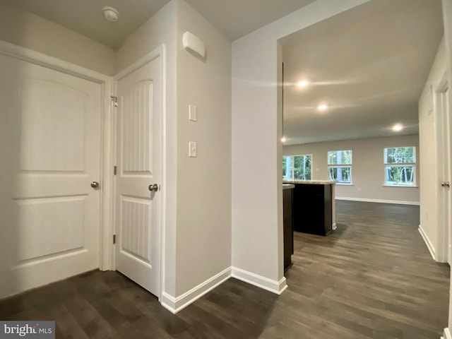 hallway with dark hardwood / wood-style flooring