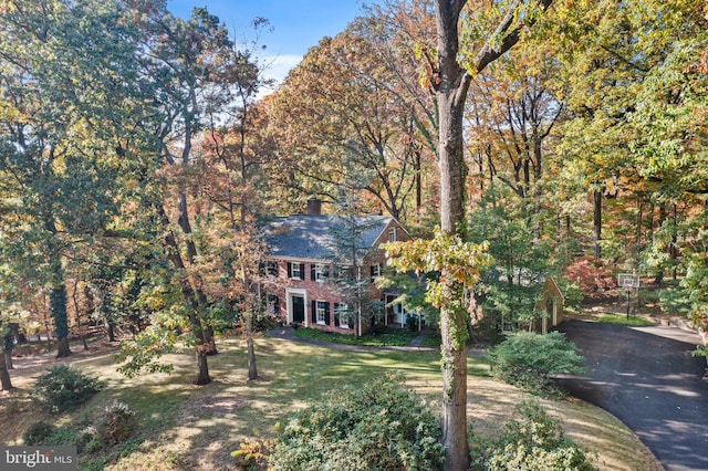 colonial home with a front lawn