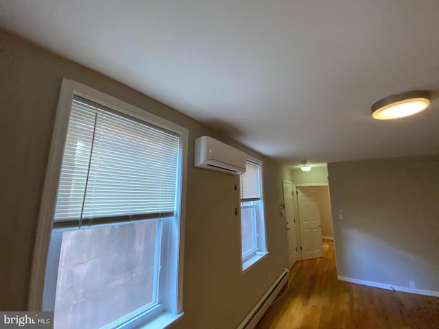 kitchen with hardwood / wood-style floors and a wall mounted AC