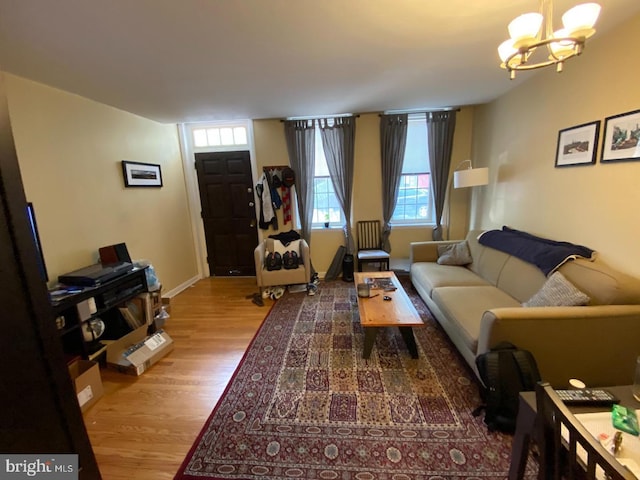 living room with hardwood / wood-style floors and an inviting chandelier