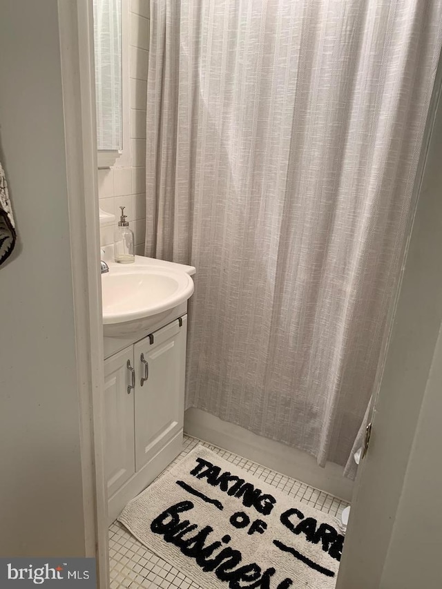 bathroom with tile patterned flooring and vanity