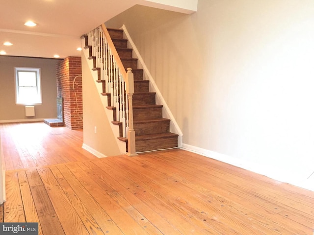 stairway with hardwood / wood-style flooring