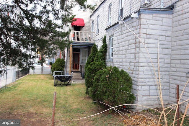 view of yard with a balcony