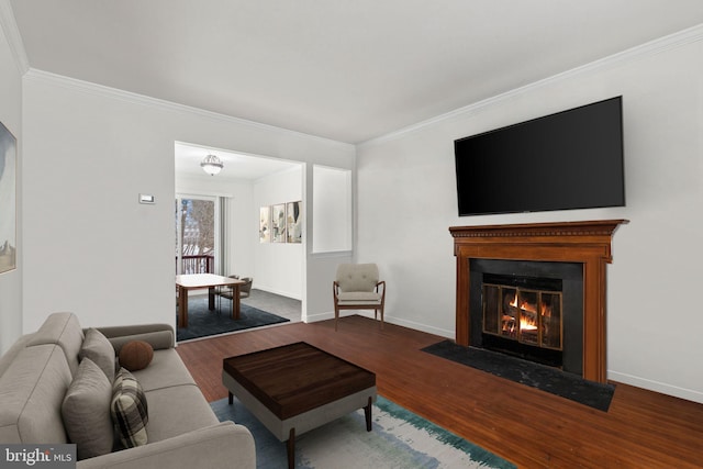 living room featuring ornamental molding and wood-type flooring