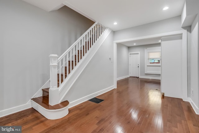 stairs with hardwood / wood-style floors