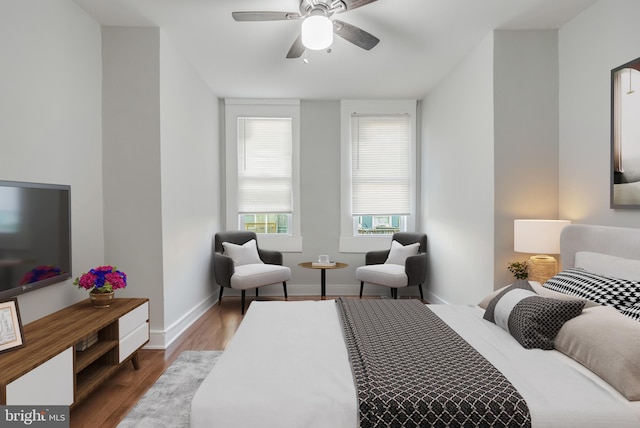 bedroom with ceiling fan and hardwood / wood-style flooring