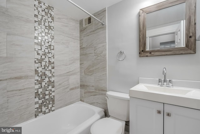 full bathroom featuring tiled shower / bath, vanity, and toilet