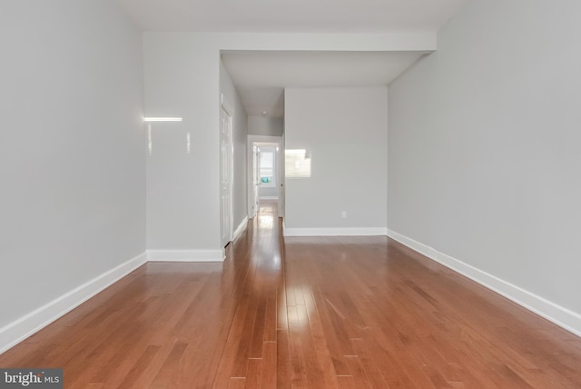 empty room with hardwood / wood-style flooring