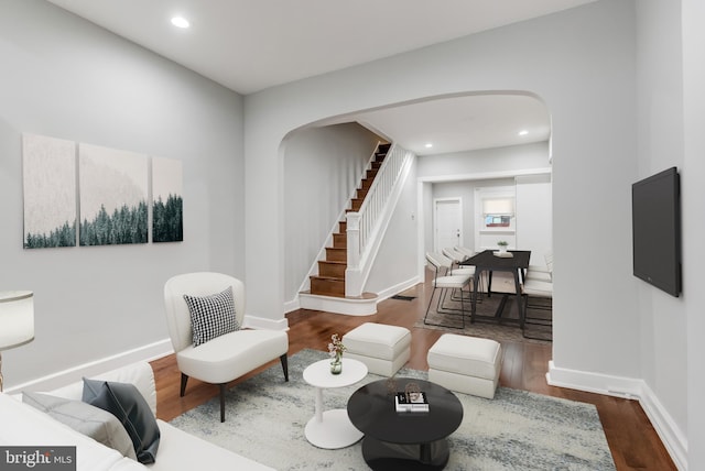 living room with dark hardwood / wood-style flooring