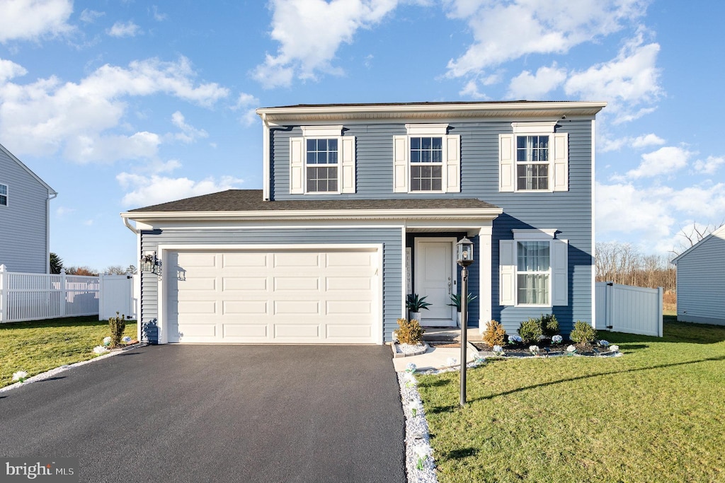 view of front property with a front yard and a garage