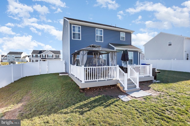 back of house featuring a gazebo, a wooden deck, and a yard