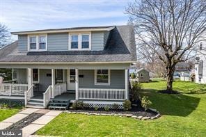 view of front of property with a front yard and a porch