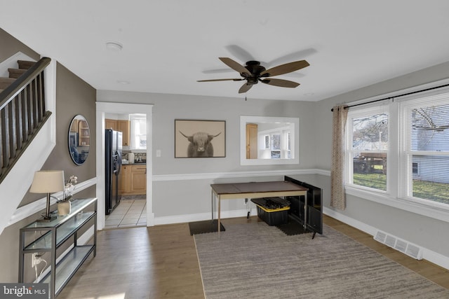 office area with ceiling fan and light hardwood / wood-style flooring