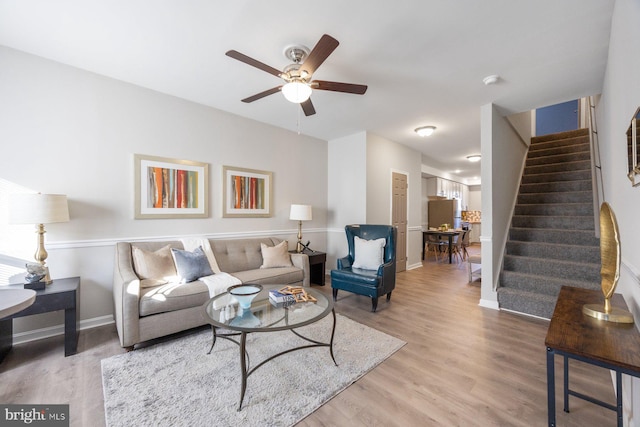 living room with ceiling fan and wood-type flooring