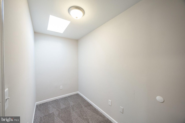 carpeted empty room with a skylight