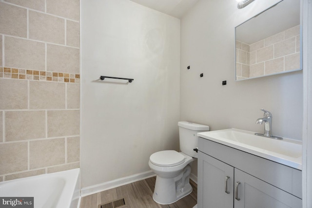 bathroom with vanity, toilet, and wood-type flooring