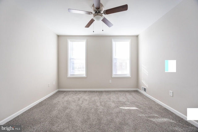 carpeted spare room with ceiling fan