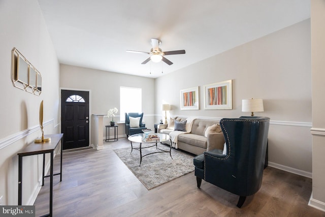 living room featuring ceiling fan and hardwood / wood-style floors