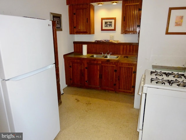 kitchen featuring white appliances and sink