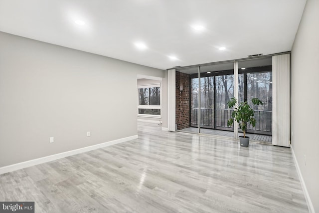 unfurnished room with light hardwood / wood-style floors