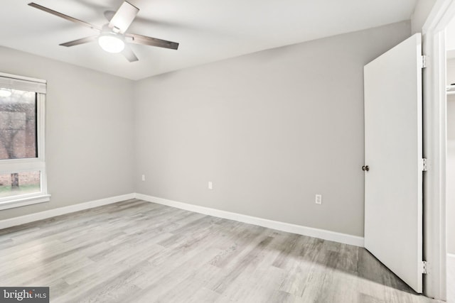 empty room featuring ceiling fan and light hardwood / wood-style flooring