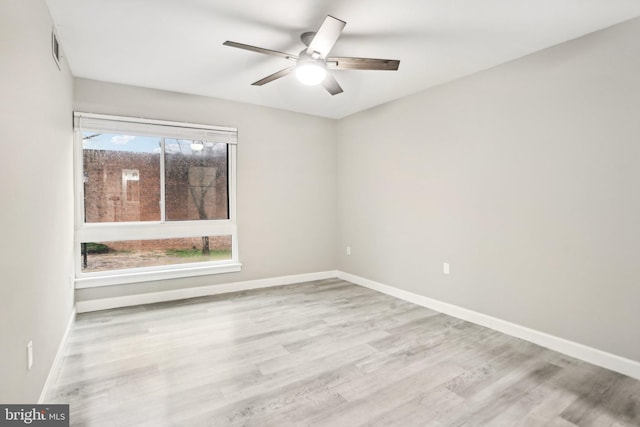 spare room featuring light hardwood / wood-style floors and ceiling fan