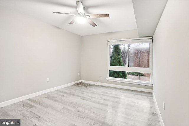 spare room with ceiling fan and light wood-type flooring