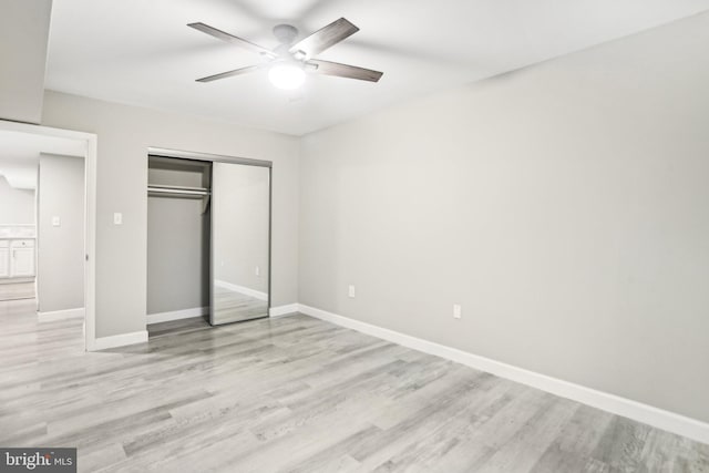 unfurnished bedroom with ceiling fan, light hardwood / wood-style floors, and a closet