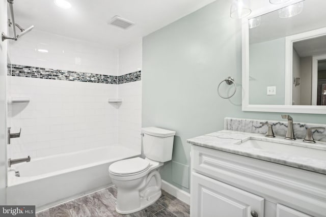 full bathroom featuring vanity, toilet, wood-type flooring, and tiled shower / bath