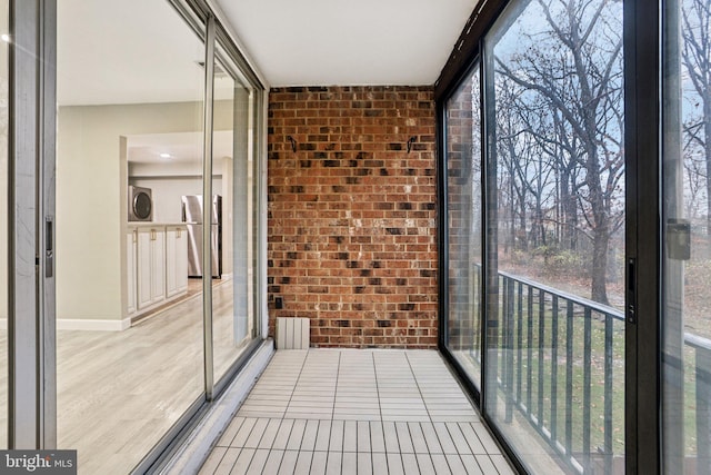 unfurnished sunroom featuring washer / clothes dryer