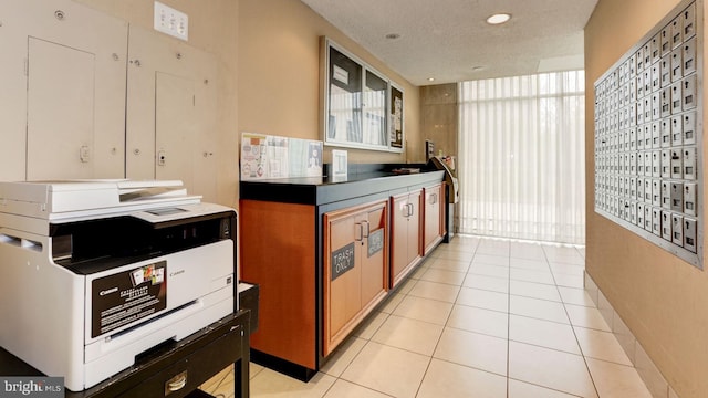 kitchen featuring light tile patterned floors and a mail area