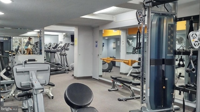 workout area featuring a textured ceiling