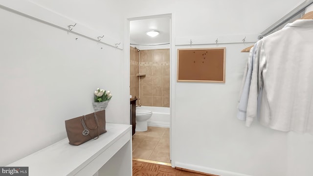 full bathroom featuring tile patterned flooring, vanity, toilet, and tiled shower / bath