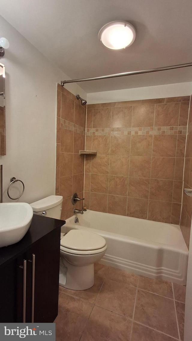 full bathroom with tile patterned flooring, vanity, toilet, and tiled shower / bath