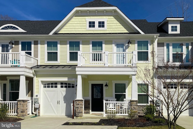 multi unit property with a balcony, covered porch, and a garage