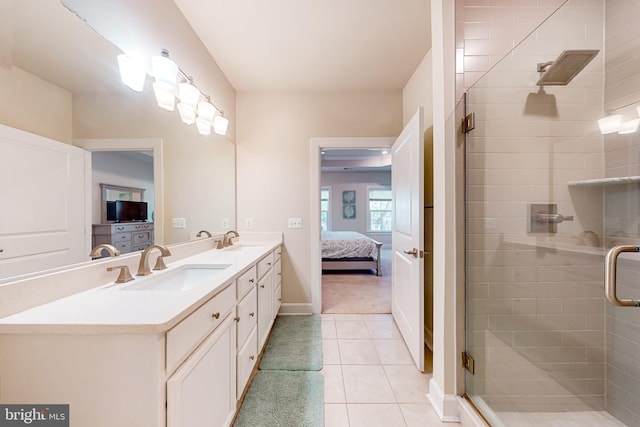 bathroom featuring tile patterned flooring, vanity, and walk in shower