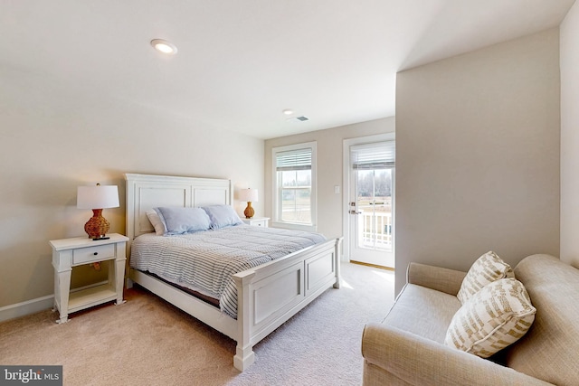 bedroom featuring light carpet and access to outside