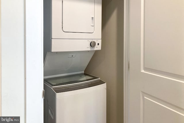 laundry area featuring stacked washer / drying machine