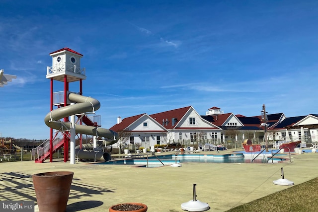 view of swimming pool with a water slide