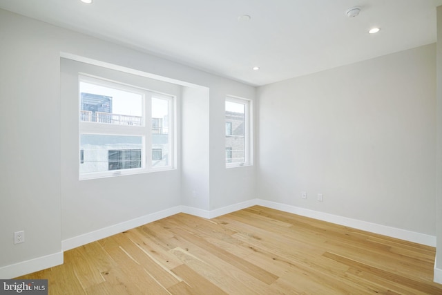 spare room with hardwood / wood-style flooring