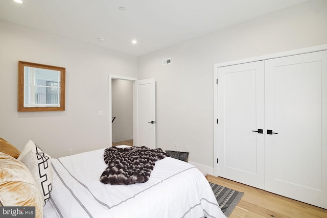 bedroom with a closet and light wood-type flooring