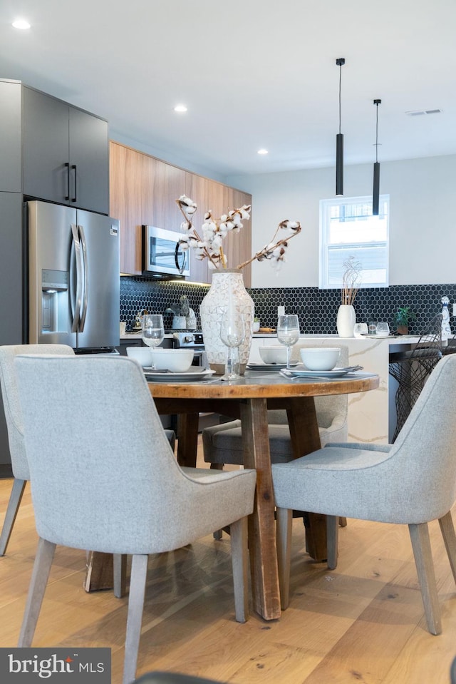 dining area with light hardwood / wood-style floors