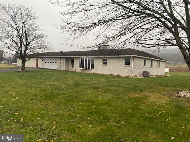 exterior space featuring a lawn and a garage