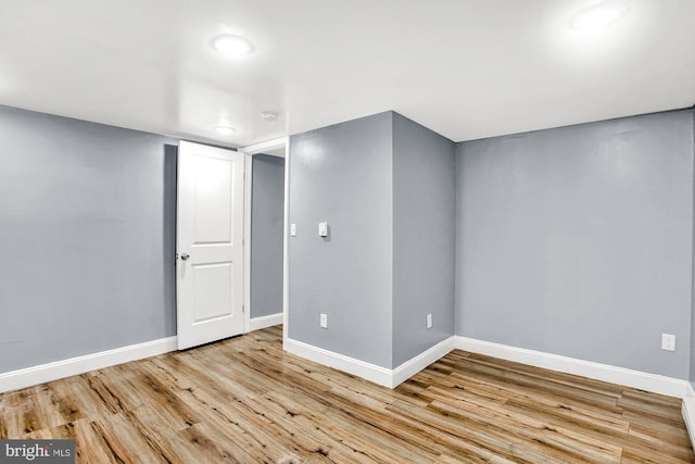 basement with light hardwood / wood-style floors